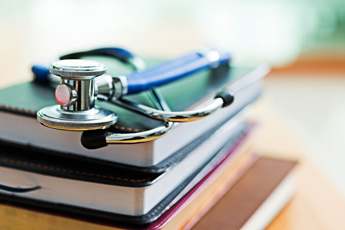 Image of a stack of books with stethescope