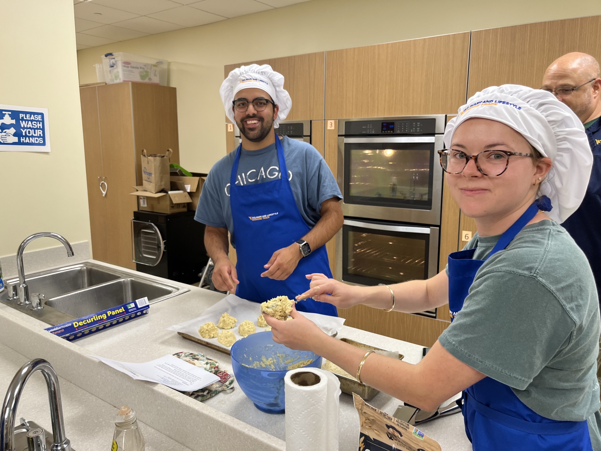 students prepare food in a kitchen