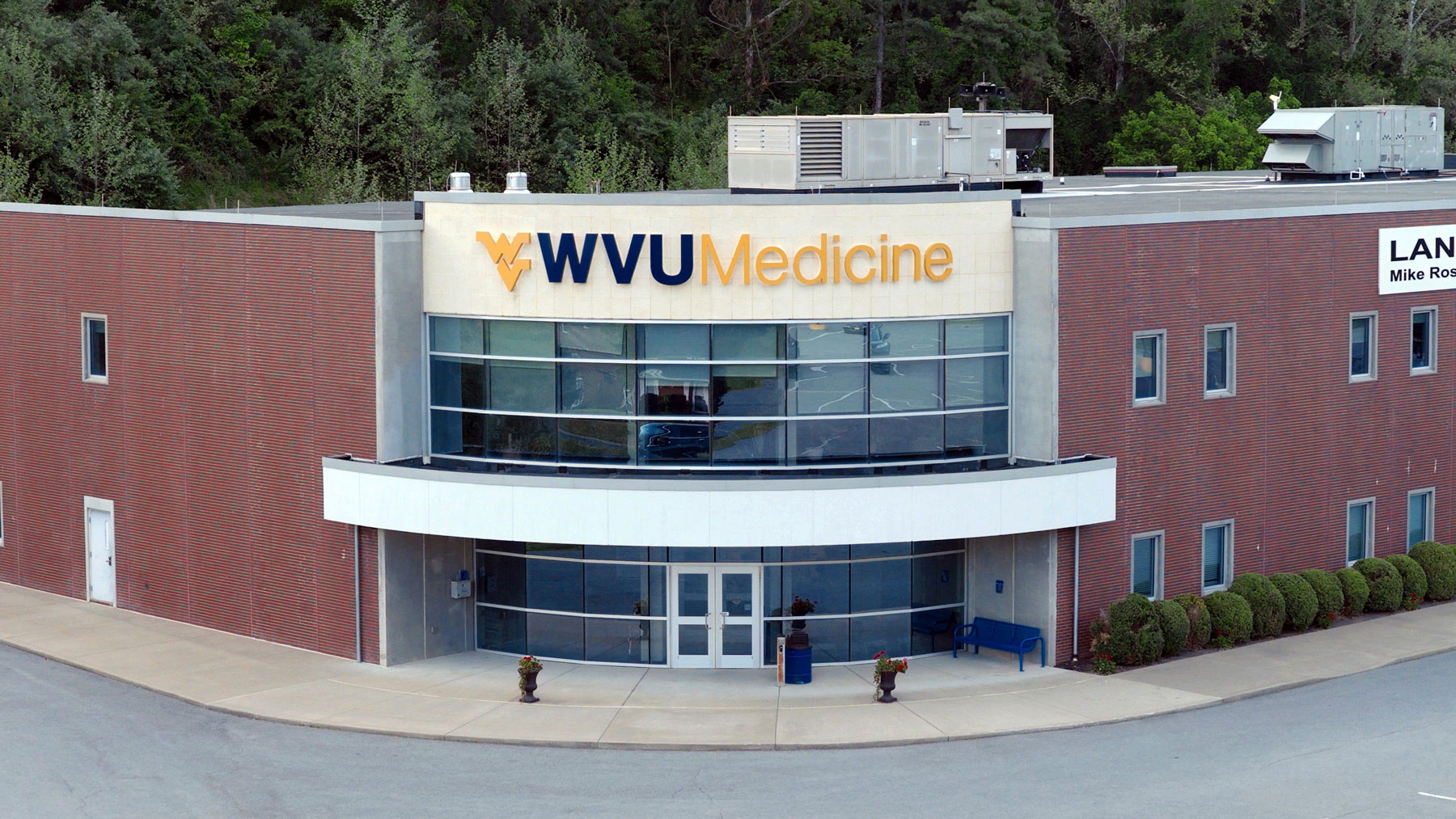 The entrance of a medical clinic with the West Virginia University logo and WVU Medicine on its signage