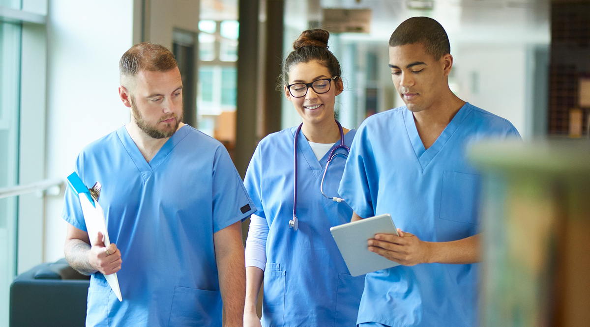 Young doctors wearing scrubs walking down the hallway